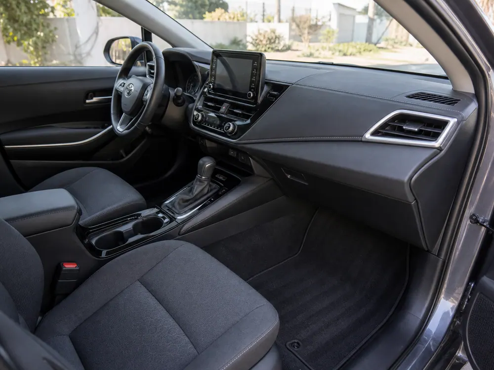 Clean car dashboard, seats, mats, and footwell after service.